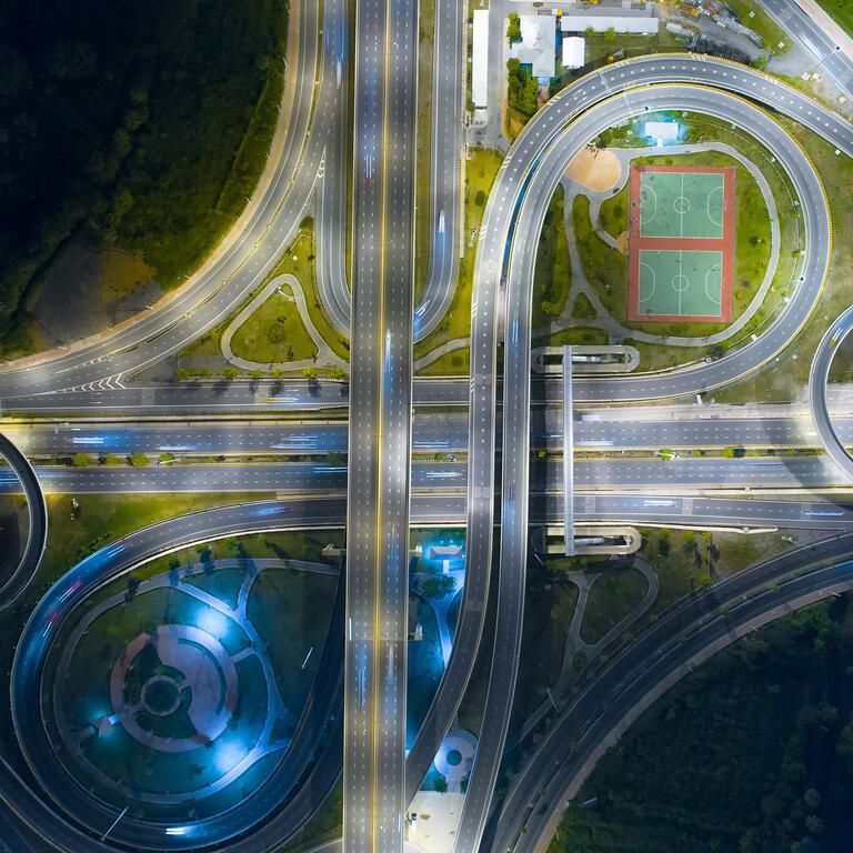 The light on the road roundabout at night and the city in Bangkok, Thailand. Aerial view. Top view. Background scenic road.